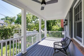 A covered porch with a ceiling fan, white railings, a bench, and a view of a residential area with trees and a parked car. - Waterfront Gem w/ Dock: 2 Mi to Dwtn Annapolis! (Annapolis)
