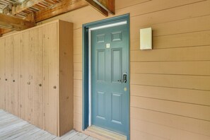 A wooden building with a blue door, a mailbox, and a wooden floor. - Shanty Creek Resort Condo Near Lake Bellaire! (Bellaire)