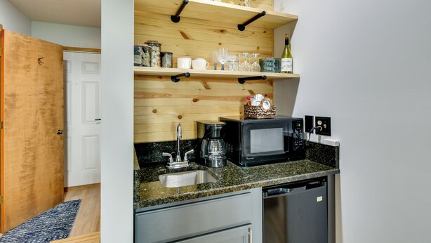 A compact kitchen with a microwave, coffee maker, and a wine bottle on the counter. - Near Slopes, Golf, Lake! Shanty Creek Resort Condo (Bellaire)