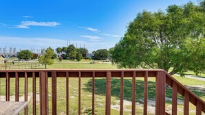 A wooden deck with a view of a grassy area and trees. - 9 Mi to Stockyards! Family Home in Fort Worth (Fort Worth)
