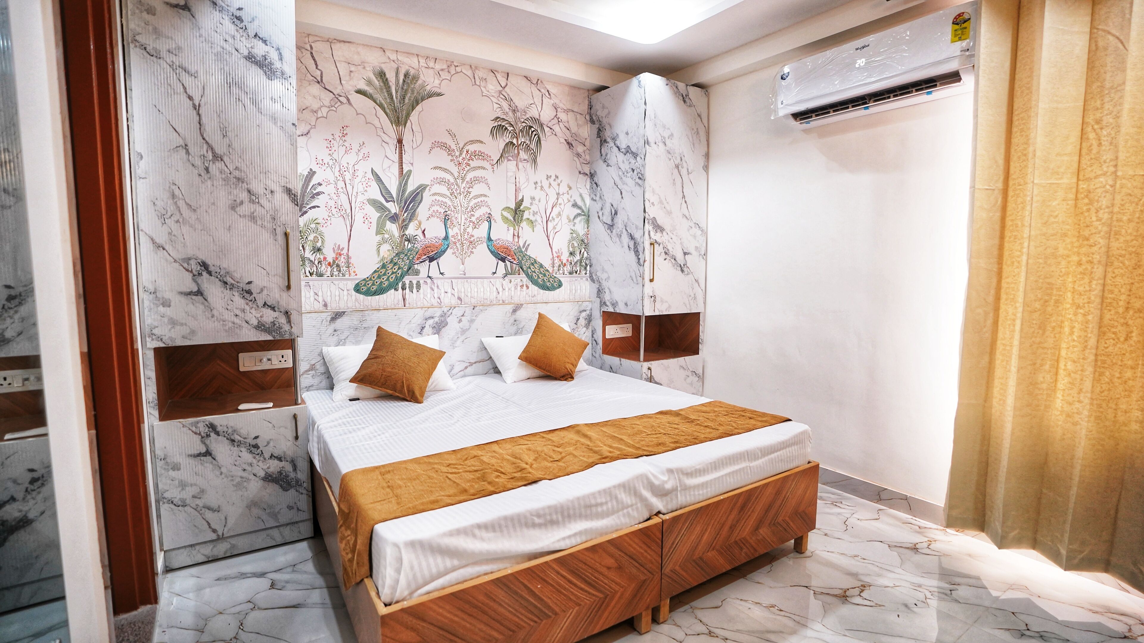 A bedroom with a bed, wooden headboard, marble-patterned walls, and an air conditioning unit.