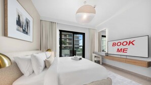 A modern hotel room with a large bed, a TV, and a view of the city. - StayShort - Stunning 2-Bedroom Apartment in Mina Rashid That Sleeps 6! (Dubai)