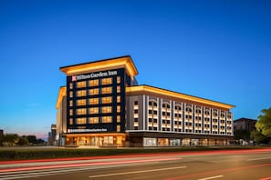 A modern Hilton Garden Inn hotel with a prominent entrance and multiple floors.