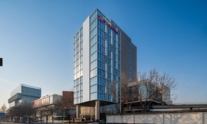 A modern multi-story building with a prominent signage at the top. - Hilton Garden Inn Beijing Fengtai Xiaotun Road (Beijing)