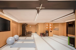 A modern fitness room with exercise equipment, yoga mats, and a water dispenser. - Hilton Garden Inn Beijing Fengtai Xiaotun Road (Beijing)