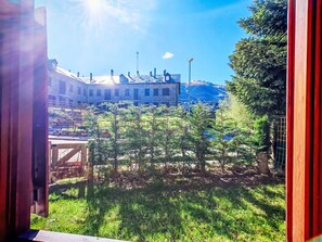 A view of a building with a sloped roof, surrounded by greenery and trees. - Apartamento - Puig Falcó 3 by Interhome (Taüll)