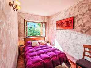 A narrow room with a bed, a window, and a wall-mounted artwork. - Apartamento - Puig Falcó 3 by Interhome (Taüll)