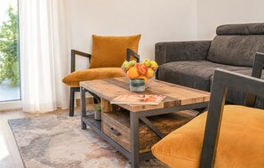A living room with a wooden coffee table, a sofa, and a chair. - Gorgeous home in Novalja (Novalja)