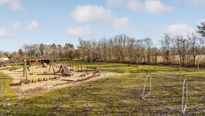 A playground with swings, slides, and a sandbox. - Stunning home in Fårvang with sauna (Fårvang)