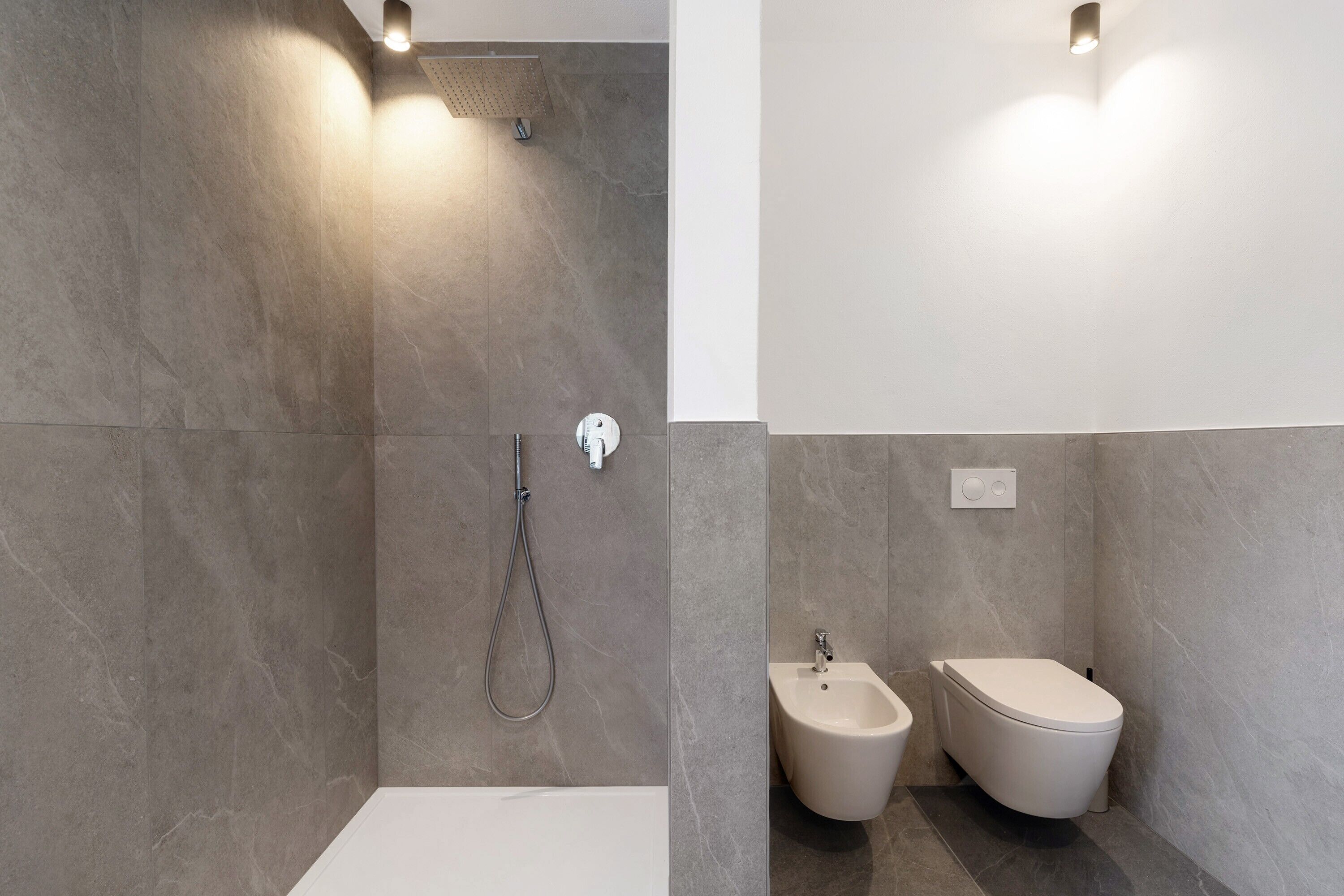 Un baño moderno con ducha, bidé y retrete.
