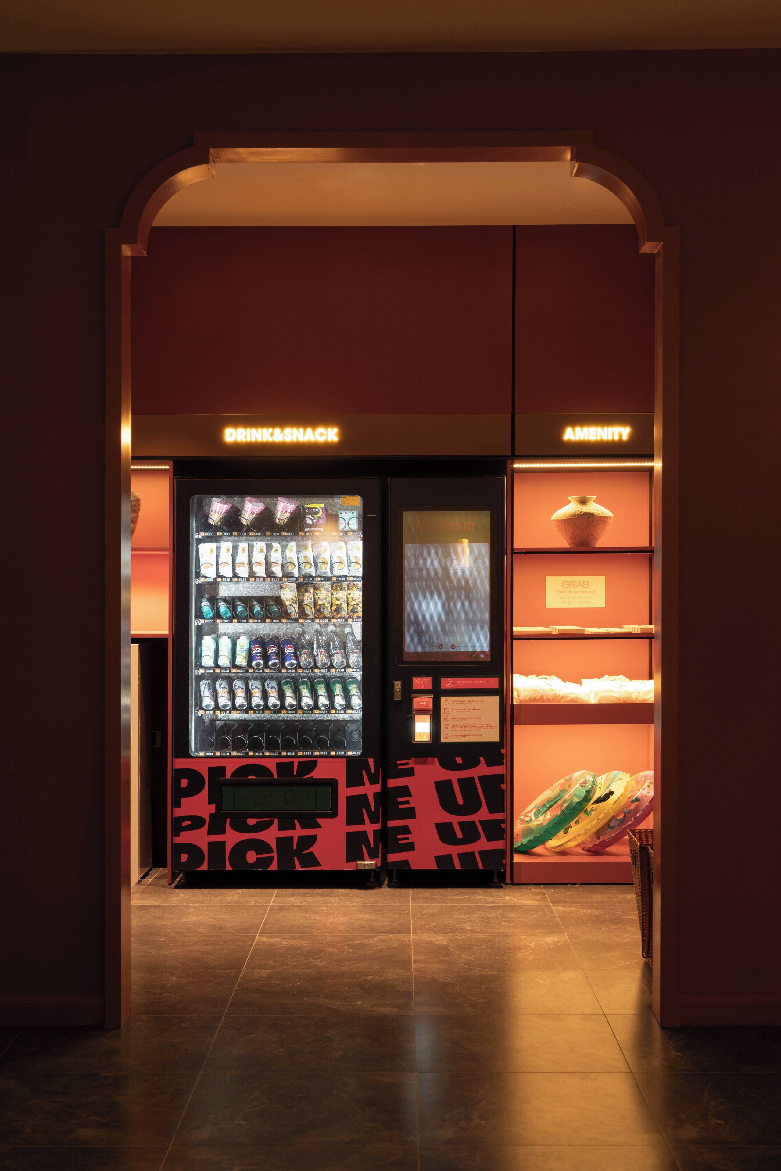 A vending machine area with drink and snack options, a digital screen, and a section labeled 'AMENITY'.