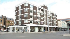 A multi-story building with a modern architectural design, featuring a mix of brick and glass facades. - The Elden - No.16 - Fairway Hosting (Greater London)