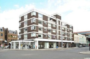 A multi-story building with a modern architectural design, featuring a mix of brick and glass facades. - The Elden - No.16 - Fairway Hosting (Greater London)