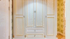 A large, ornate wardrobe with multiple doors and drawers. - Manzhouli Junyu Grand Hotel (Manzhouli Wanda Plaza Matryoshka Square) (Manzhouli)