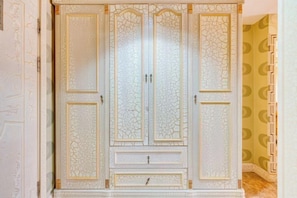 A large, ornate wardrobe with multiple doors and drawers.