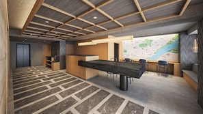 A modern interior with a central dining table, a reception desk, and a map on the wall. - Minn Asakusa Hanayashiki North (Tokyo)