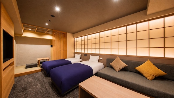 A hotel room with two beds, a sofa, a TV, and a sliding shoji screen. - Minn Asakusa Hanayashiki North (Tokyo)