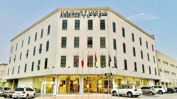 A multi-story hotel building with a prominent sign at the top.