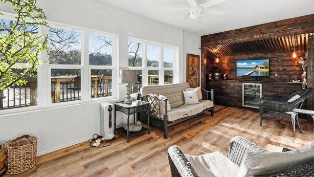 A spacious living area with a sofa, chairs, a fireplace, and a television. - Lakefront walk-in condo overlooking Marina (Branson)