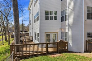 A two-story residential building with a deck, a covered patio, and a visible garage. - Lakefront walk-in condo overlooking Marina (Branson)