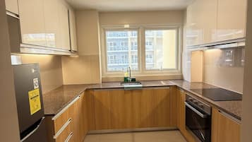 Family Condo, Balcony, Pool View | Private kitchen | Full-sized fridge, microwave, stovetop, cookware/dishes/utensils