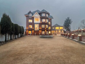 A large, multi-story building with a central courtyard, surrounded by a fence and trees. - Palette Hotel Cecil Srinagar (Srinagar)