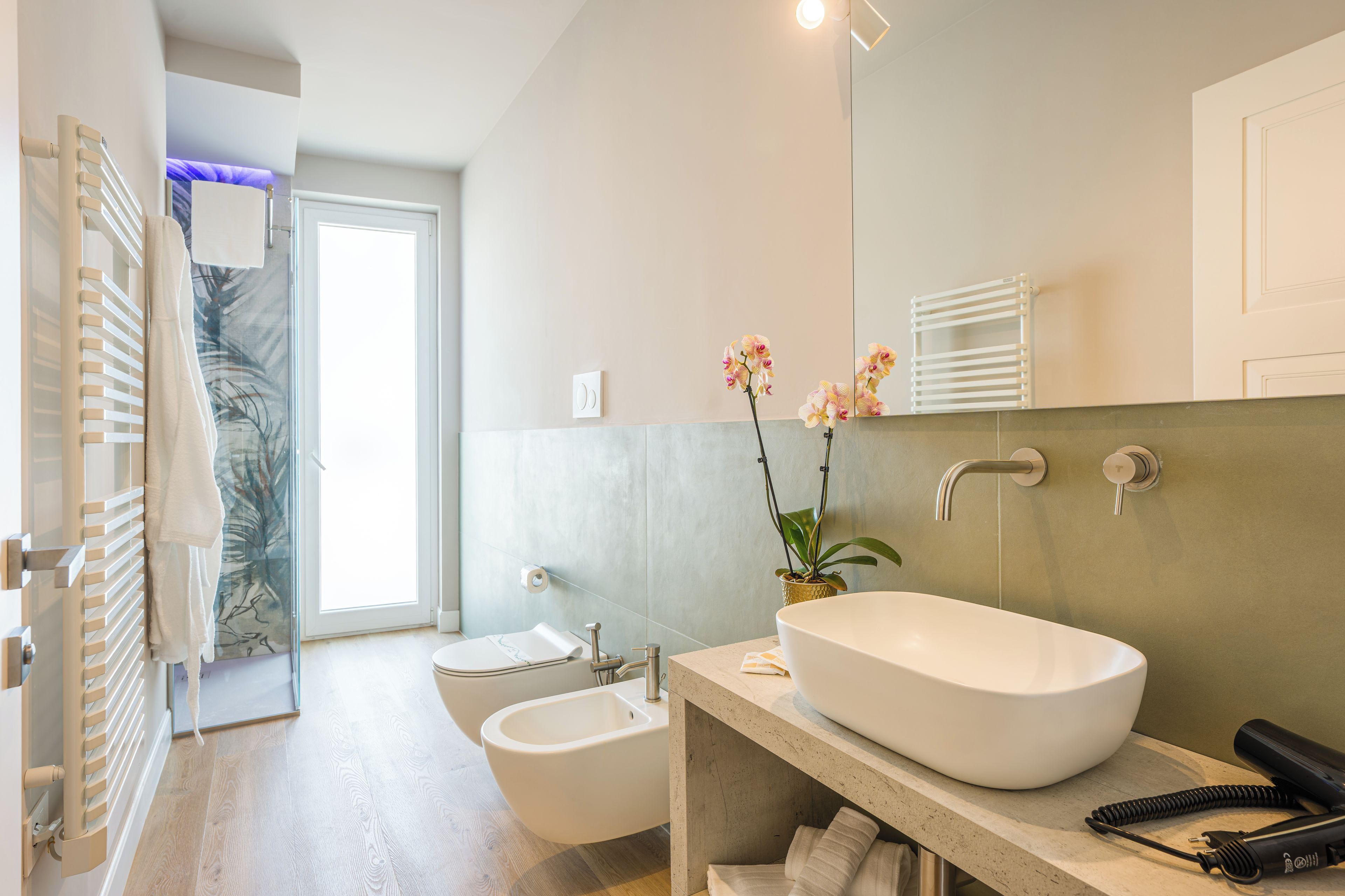 A modern bathroom with a freestanding bathtub, a bidet, and a toilet.