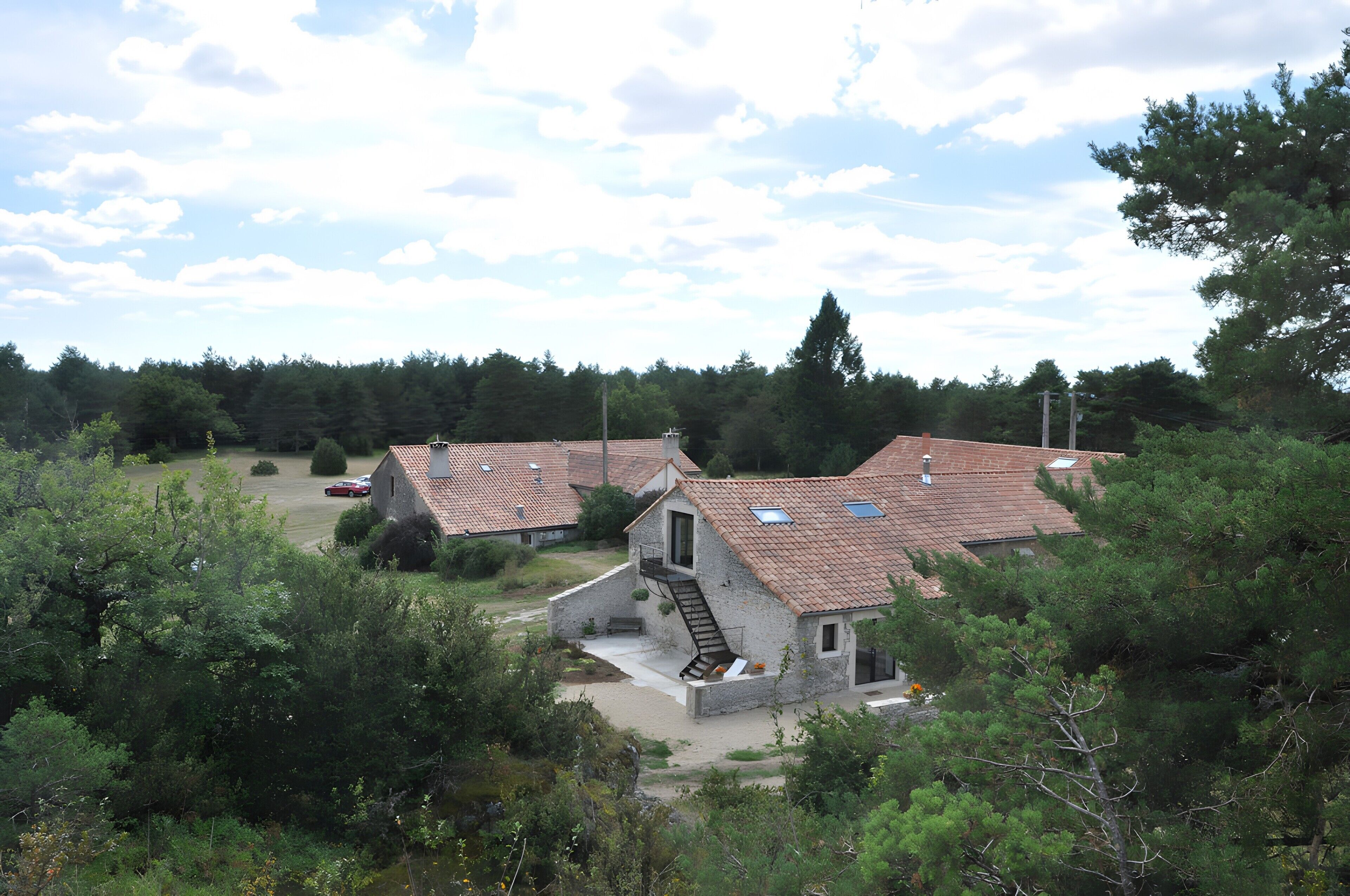 A residential area with houses featuring sloped roofs and a stone foundation.