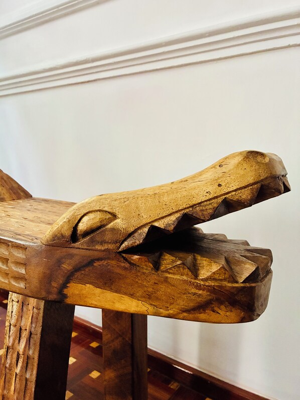 A wooden chair with a carved animal headrest. - Chic 3-bedroom townhouse in heart of Roma Norte (Ciudad de México)