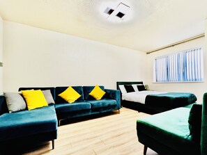 A room with a sofa set, a bed, and a window with curtains. - Hockley 4-bed, Sleeps 12 w/ Garden & Free Parking (Birmingham)