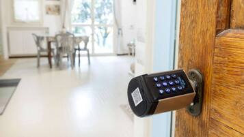 A door with a keypad lock and a QR code.