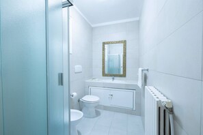 A bathroom with a toilet, sink, mirror, and radiator. - Charming Modern Loft With Sea View in Riccione Hills (Riccione)