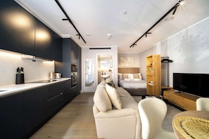 A modern kitchen with dark cabinetry, a countertop, and a built-in oven. - 9 Mins Walk to Selfridges, Marble Arch Studio (Greater London)