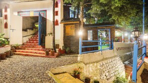 A building with a staircase, a blue railing, and potted plants. - Palette Bhatta Falls Formerly Meru Pahad (Mussoorie)