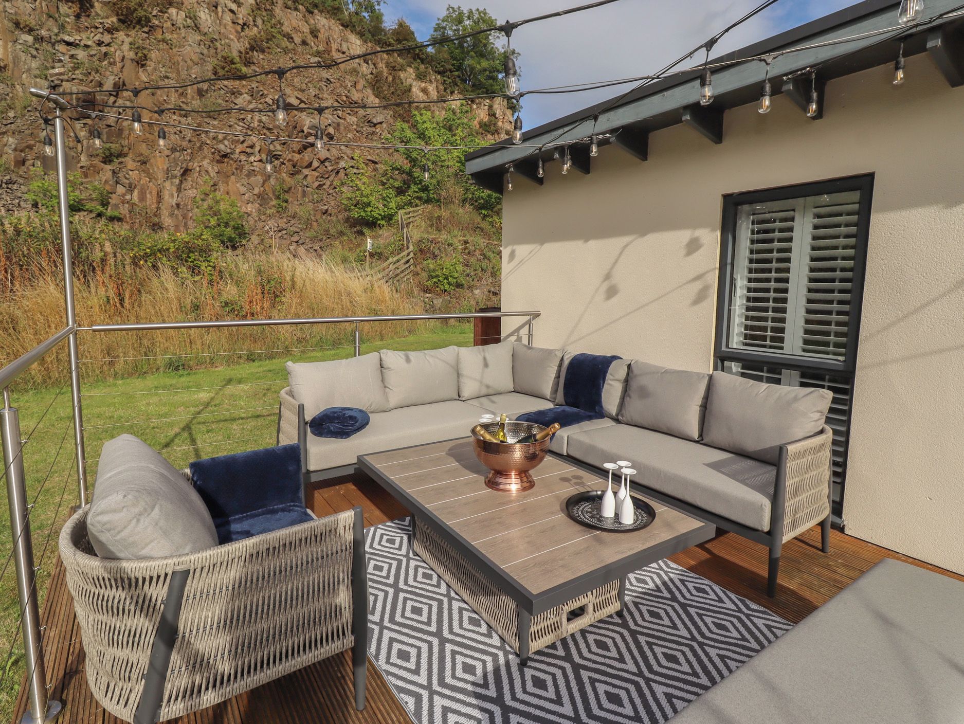 An outdoor seating area with a sofa, chairs, and a coffee table.