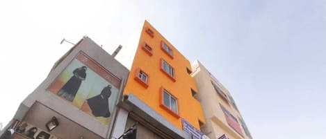A multi-story building with a storefront on the ground floor.