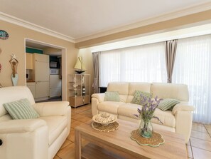 A living room with a sofa, coffee table, and decorative items. - Centrally located Sea You Again by Interhome (Blankenberge)