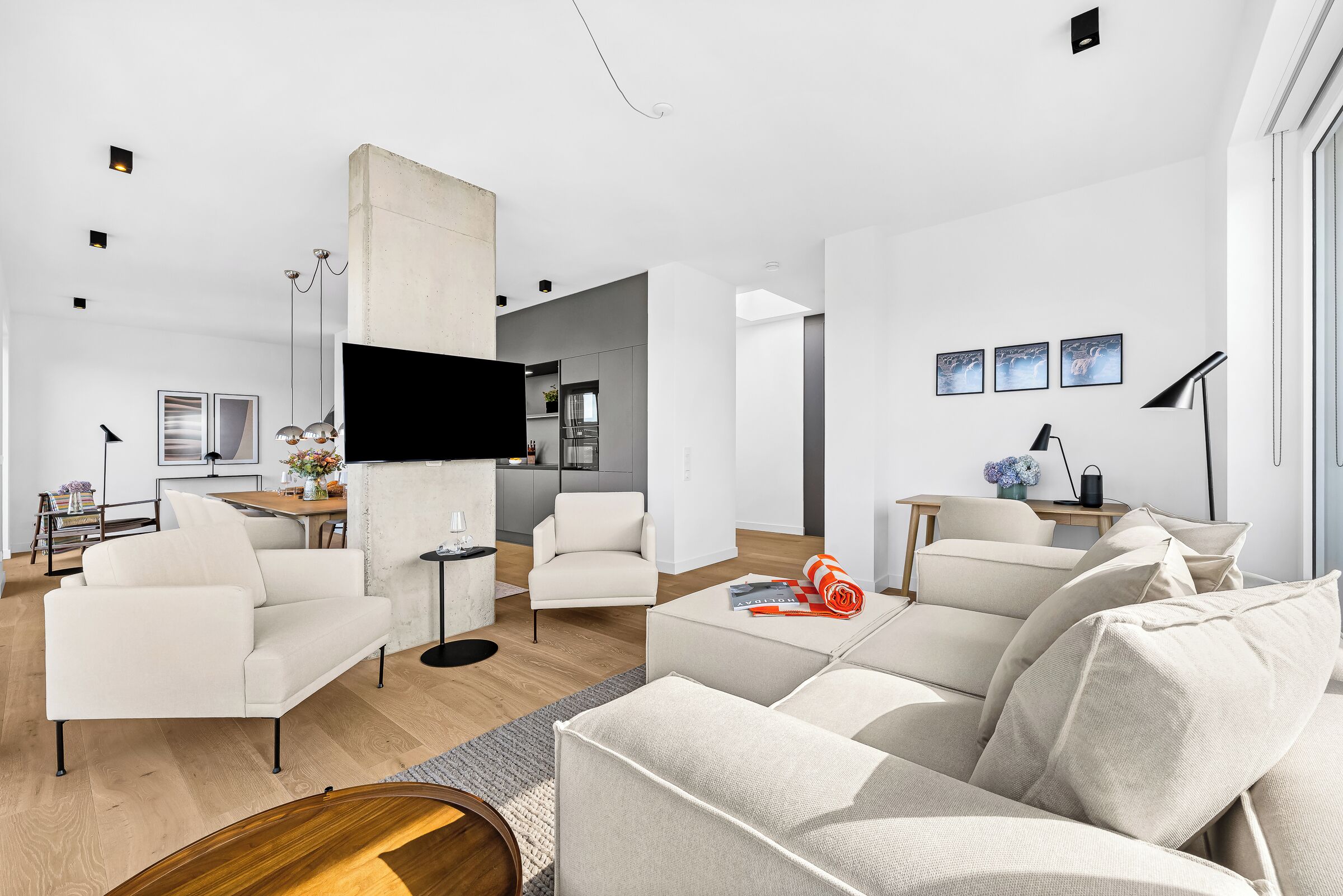 A modern living room with a sofa, a coffee table, and a TV.