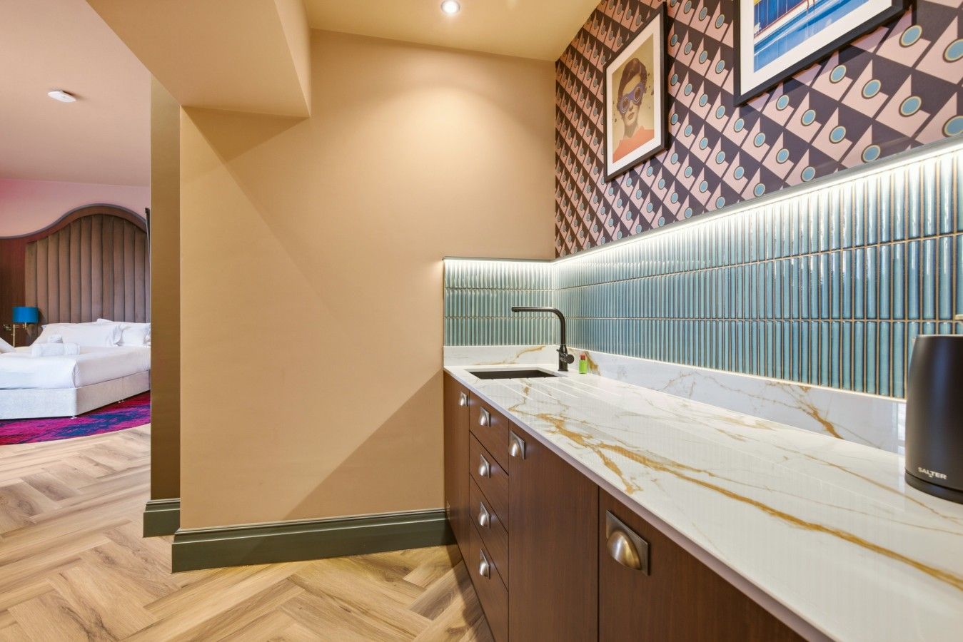 A modern bathroom with a marble countertop, a sink, and a wall-mounted mirror.