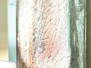 A close-up of a textured wall with peeling paint.