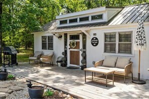 A house with a porch, outdoor seating, and a sign that reads 'YAZIGAN ESCAPE.'