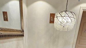 A dining area with a wooden table, chairs, a chandelier, and a mirror on the wall. - Spacious Bergen House With Stunning Mountain Views (Bergen)