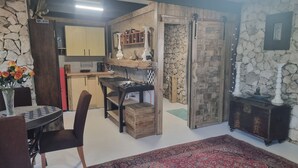 Un espacio habitable compacto con cocina, comedor y una pequeña entrada.