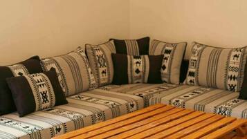 A room with a sofa, a wooden table, and three wall-mounted circular decorations.