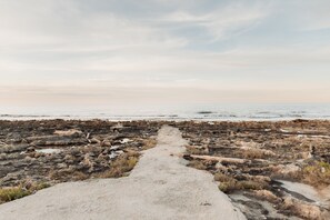 A rocky beach path leading to the ocean. - Villa Tufara | Ocean View & Private Beach (San Vito)