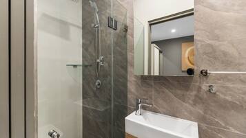 Shower, hair dryer, towels, toilet paper