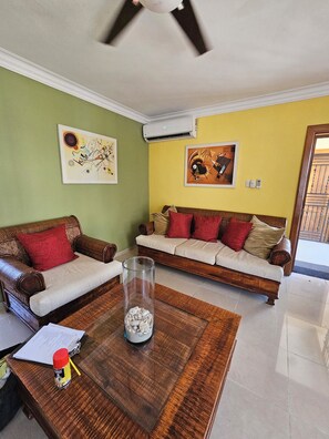 Ein Wohnzimmer mit zwei Sofas, einem Couchtisch und Wandbildern.