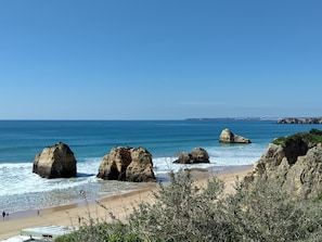 A coastal landscape with large rock formations, a sandy beach, and a clear blue sky. - Solmonte Apartment - Pool Access, Beach Close (Portimão)