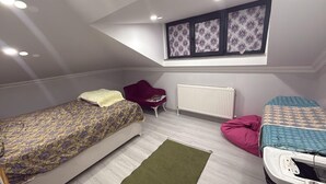 A bedroom with two beds, a radiator, a chair, and a skylight. - Cozy 2 Seprate Bedroom Apartment in Küçükçekmece With Stunning Views (Istanbul)