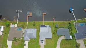 An aerial view of a residential area with houses, a dock, and a swimming pool. - Waterfront Paradise in Punta Gorda The Boat House (Punta Gorda)